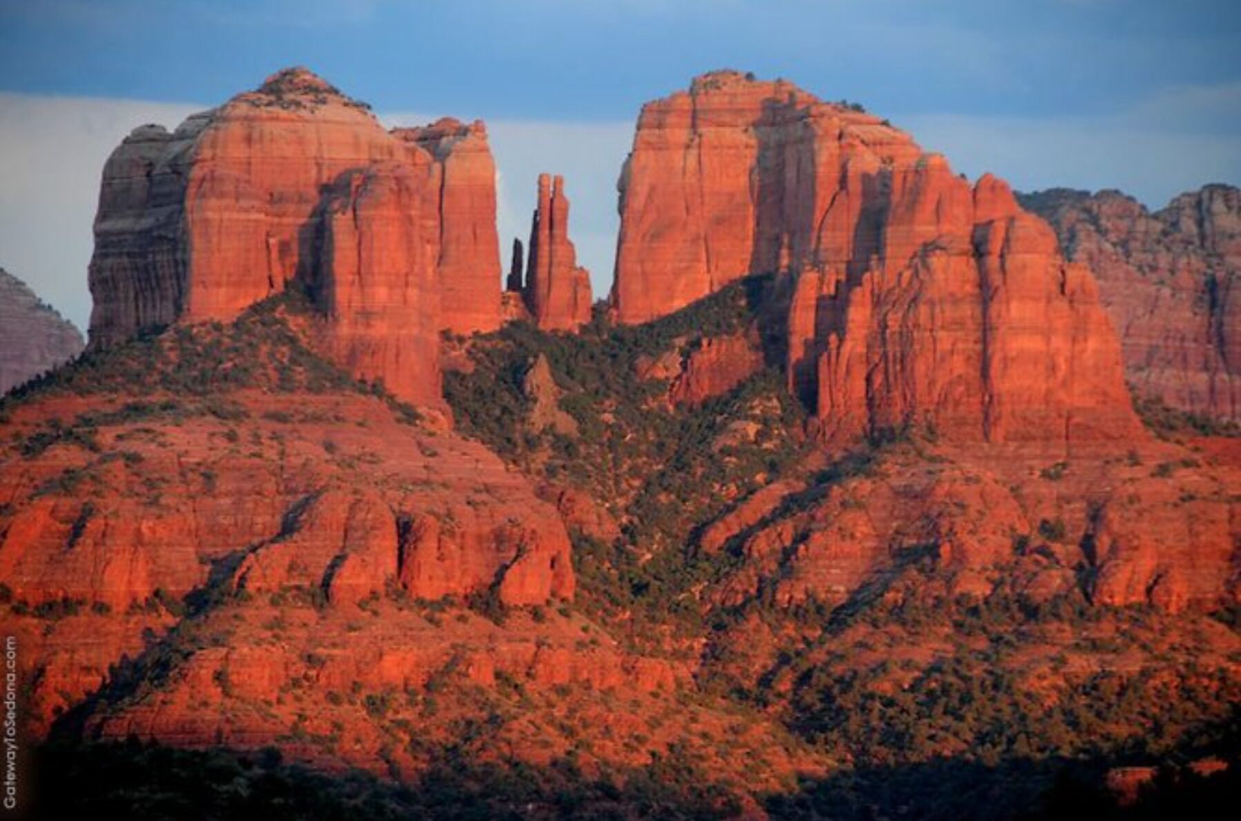 A rugged landscape with prominent red rock formations.