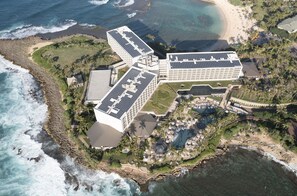 An aerial view of a resort with multiple buildings, a pool area, and a beach. - Turtle Bay Condo: Hawaiian Style & Cozy! Permit: 2211-CCH-0078 (Kahuku)