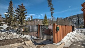 A gated entrance with a sign indicating the hot tub closes at 10:00 PM.
