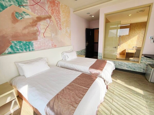 A hotel room with two beds, a large mirror, a bathroom with a glass door, and a painting on the wall. - Starry Inn (Xincheng)