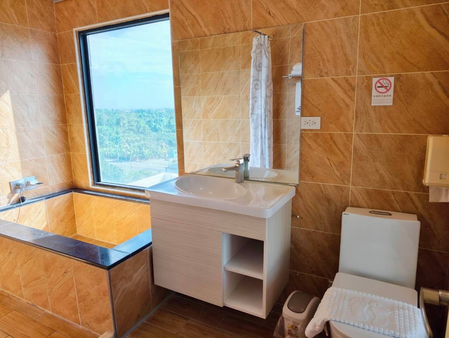 A bathroom with a bathtub, sink, and toilet.