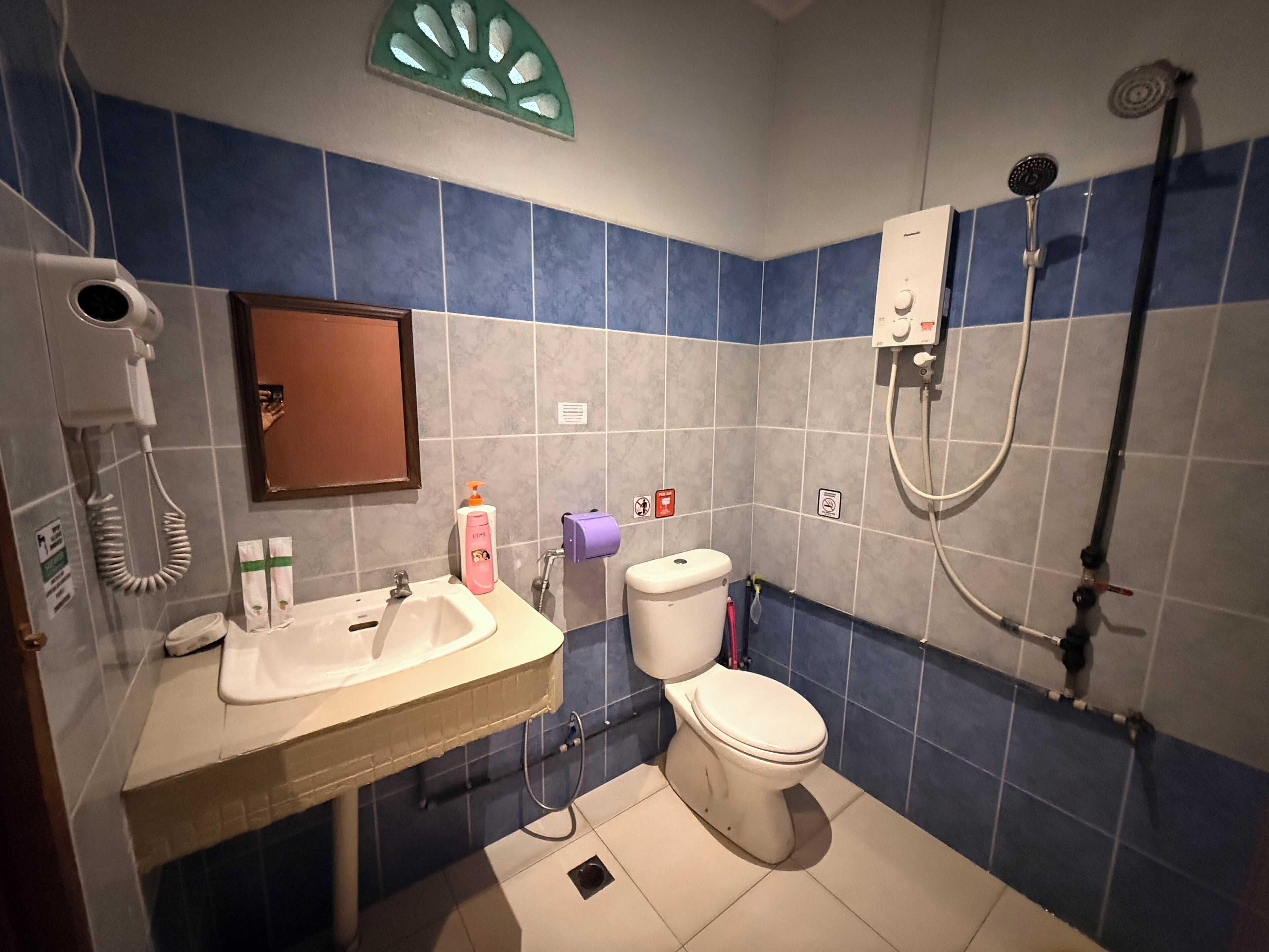 A bathroom with a sink, toilet, and shower.