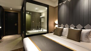 A modern hotel room with a large bed, a glass-enclosed bathroom, and a dark wood headboard. - SHANGHAI-DECO Hotel (Shanghai)