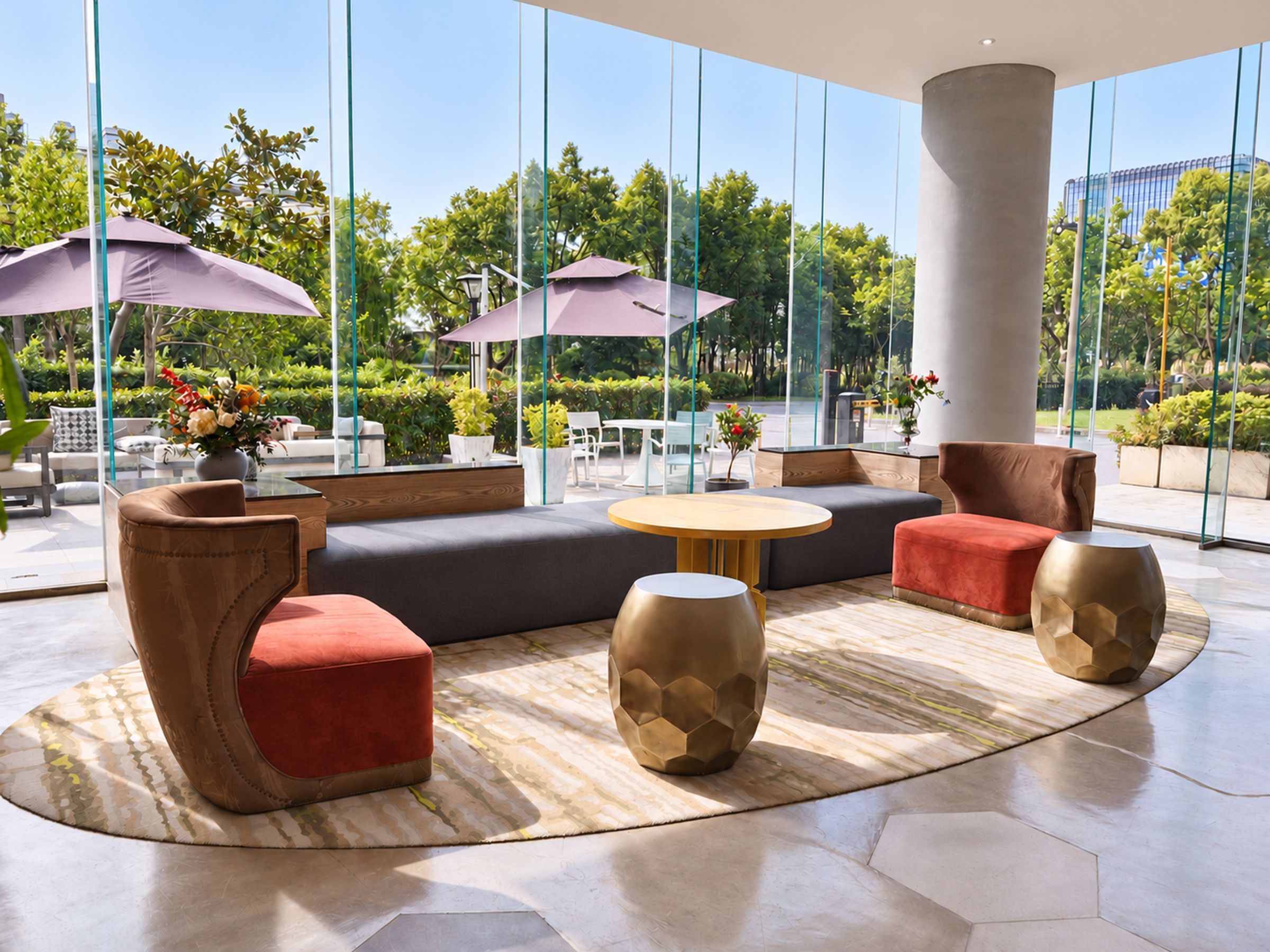 A modern outdoor seating area with sofas, chairs, and tables, surrounded by large windows offering views of greenery.