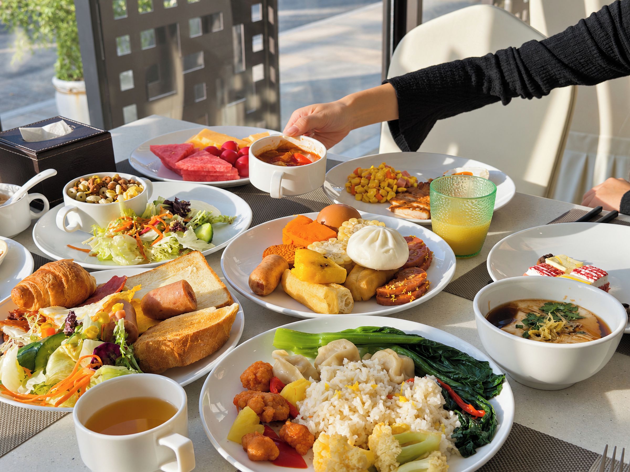 A table set with various breakfast dishes including eggs, toast, and vegetables.