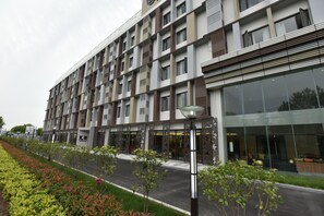 A modern multi-story building with a mix of window styles and a glass facade. - SHANGHAI-DECO Hotel (Shanghai)