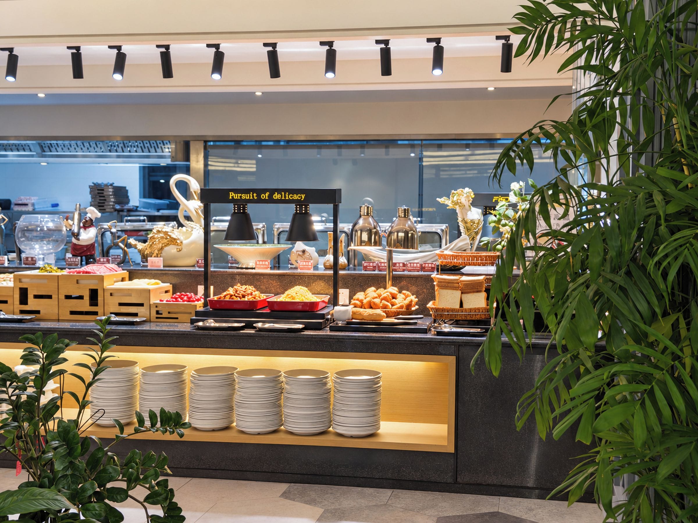 A buffet area with various food items and a sign that reads 'Pursuit of delicacy.'