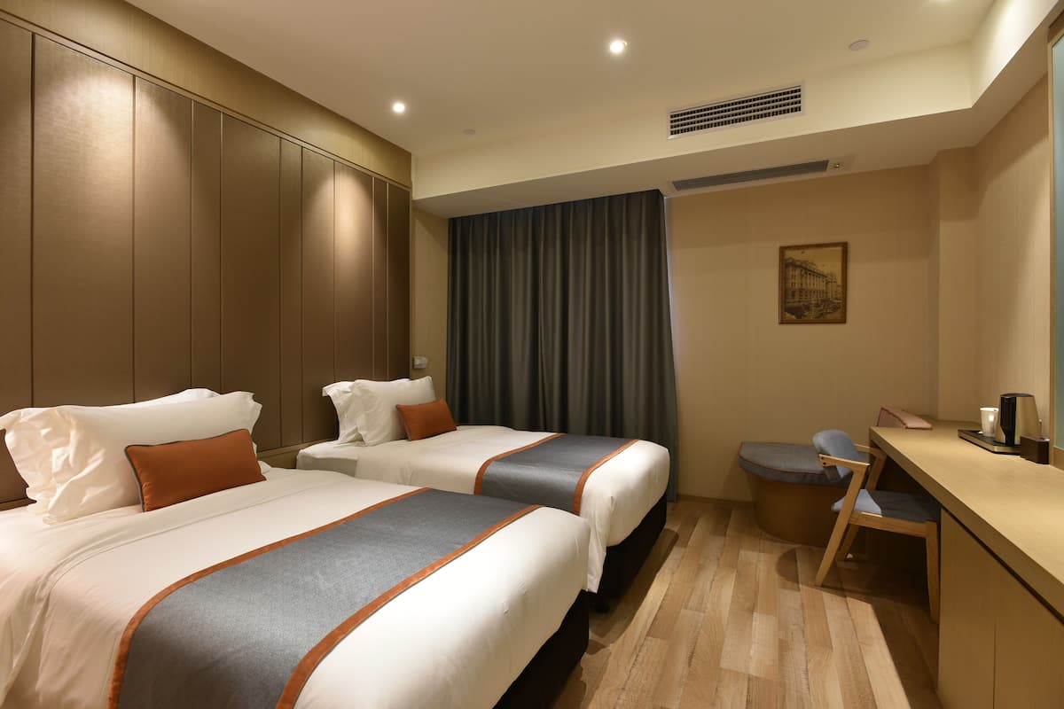 Deluxe Twin Bed | Premium bedding, desk, blackout curtains, soundproofing
