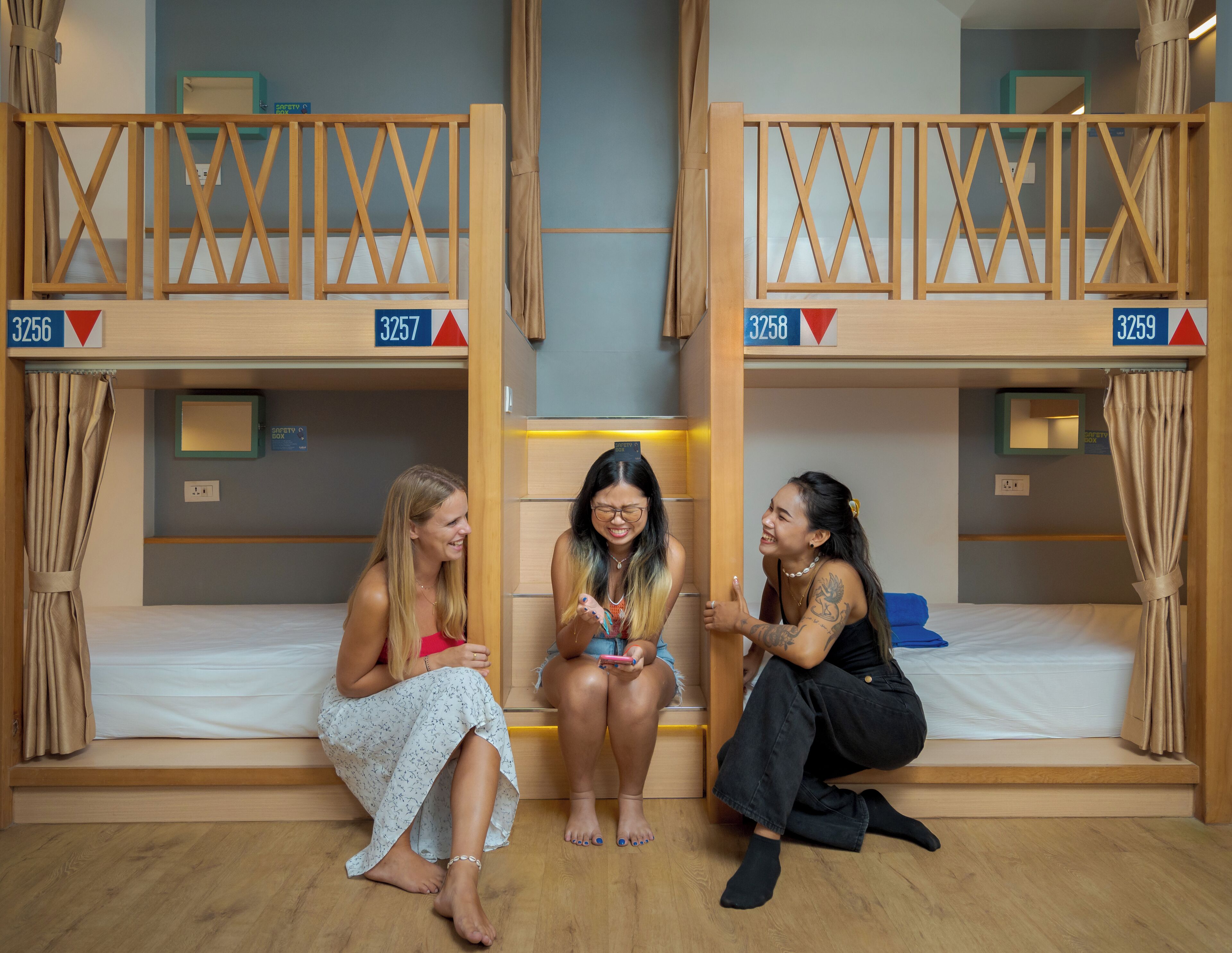 A dormitory room with bunk beds, each labeled with a number.