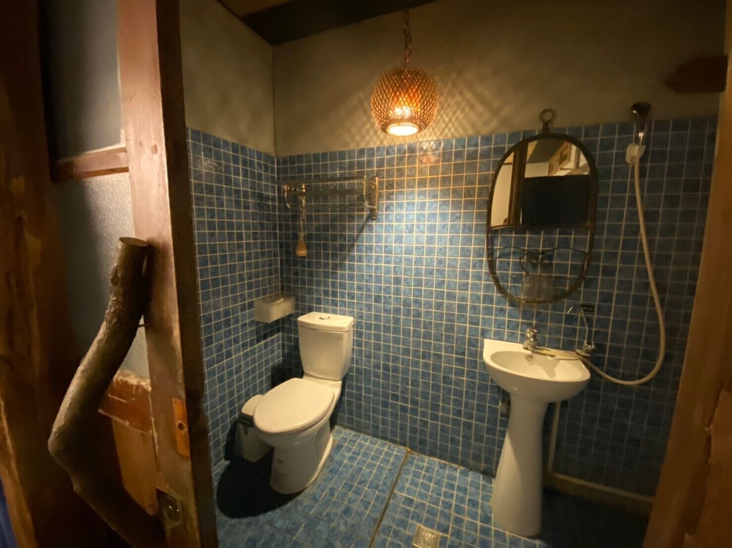 A bathroom with a toilet, sink, and shower.