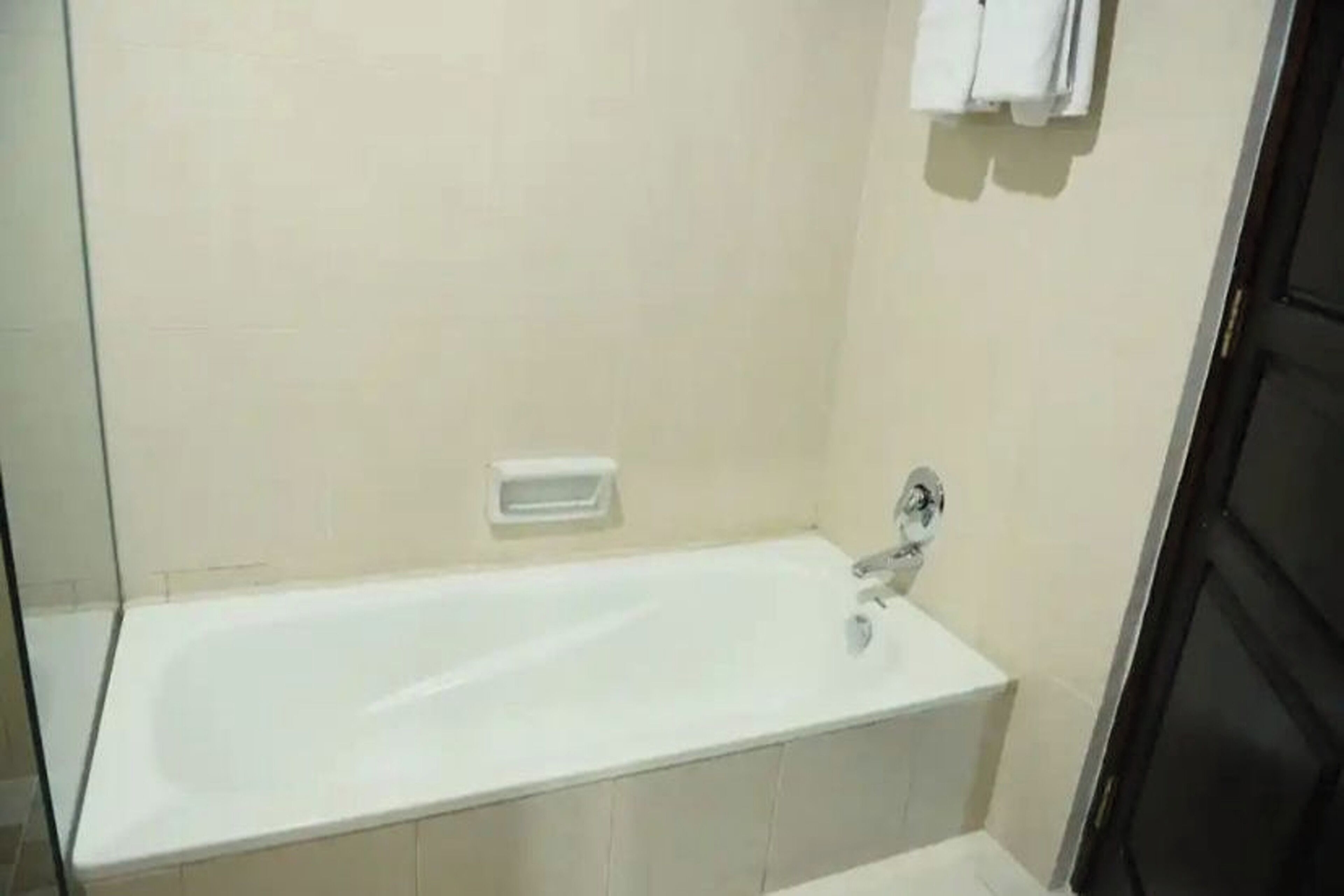 A standard bathroom with a bathtub, a sink, and a towel rack.