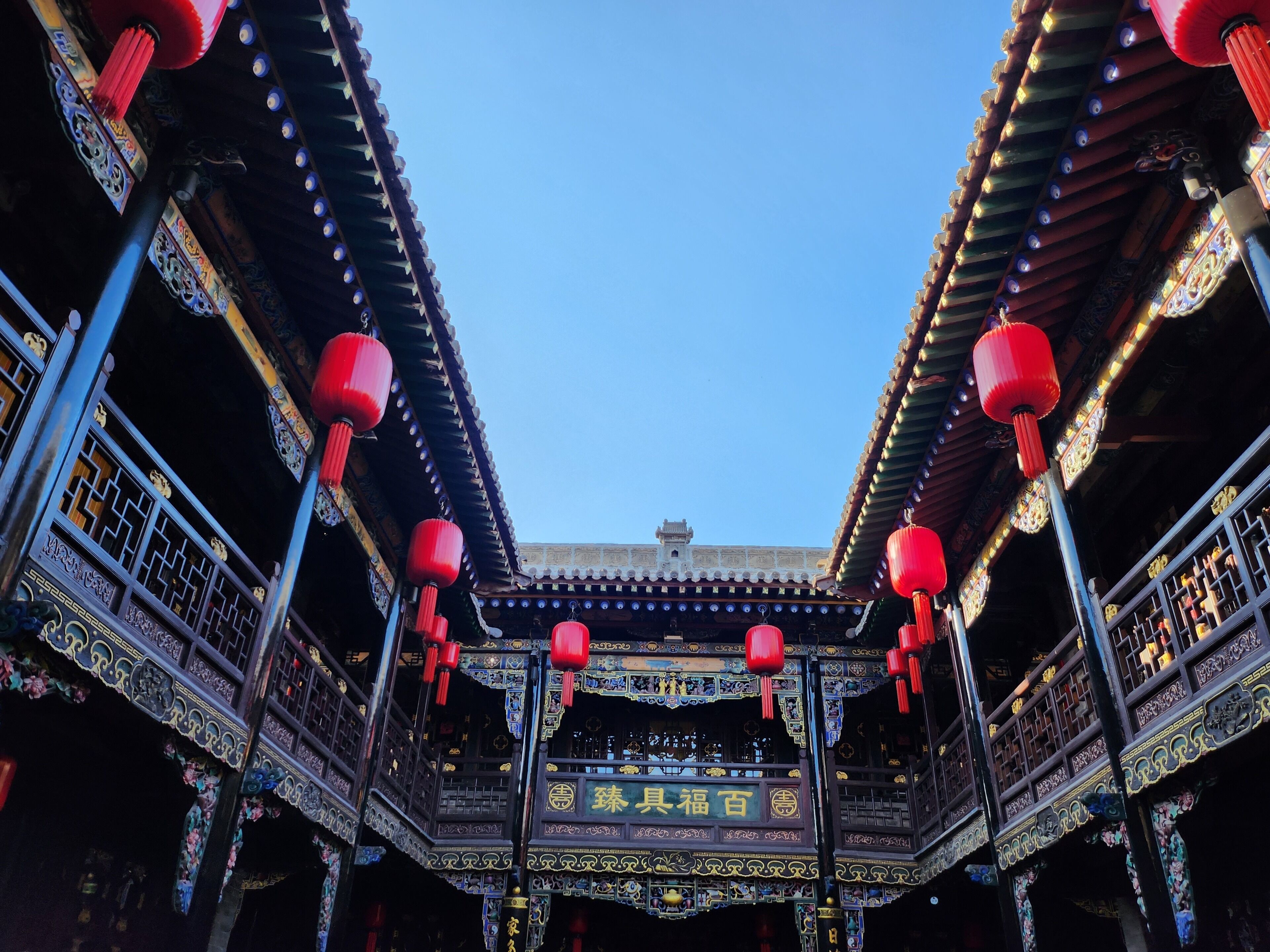 A traditional Chinese building with ornate decorations and red lanterns.