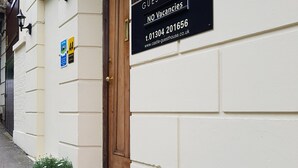 A building with a sign reading "Castle House Guest House" and a "NO Vacancies" notice. - Castle Guest House (Dover)