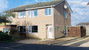 A two-story residential building with a brick facade, a tiled roof, and a satellite dish. - Abbey House (Towcester)