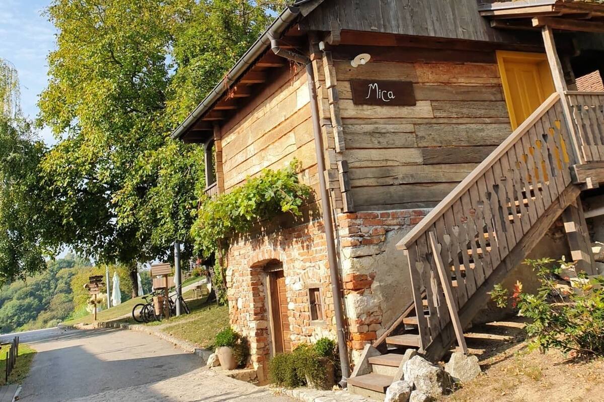 A rustic wooden building with a sign reading "Mica."