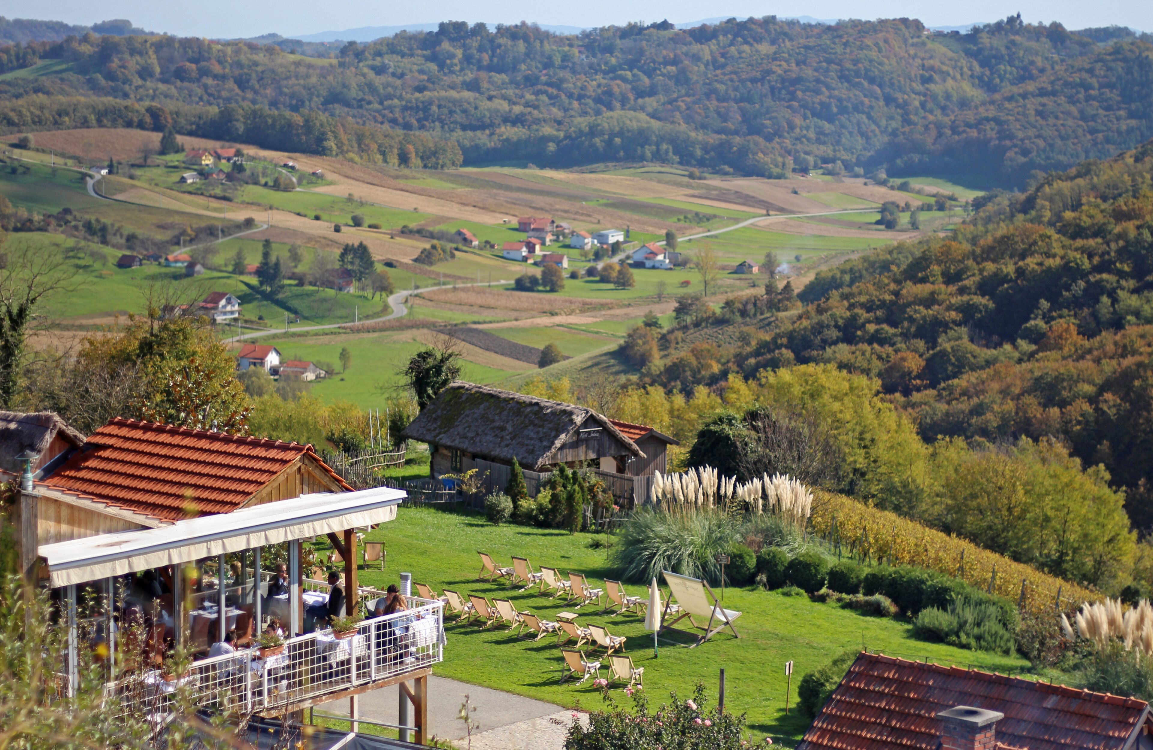 A rural landscape with a restaurant and outdoor seating area.