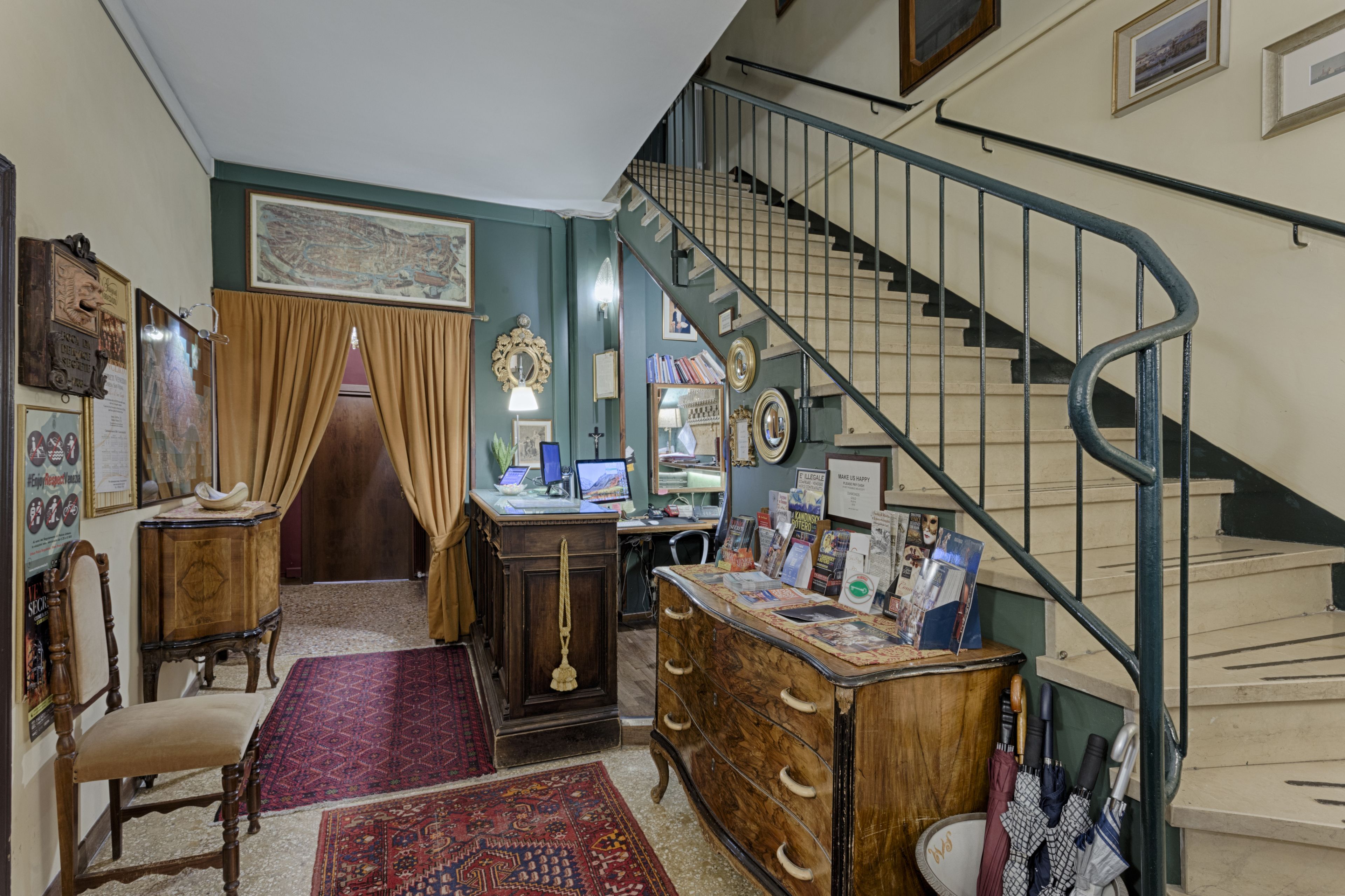 A room with a desk, chair, and a staircase.