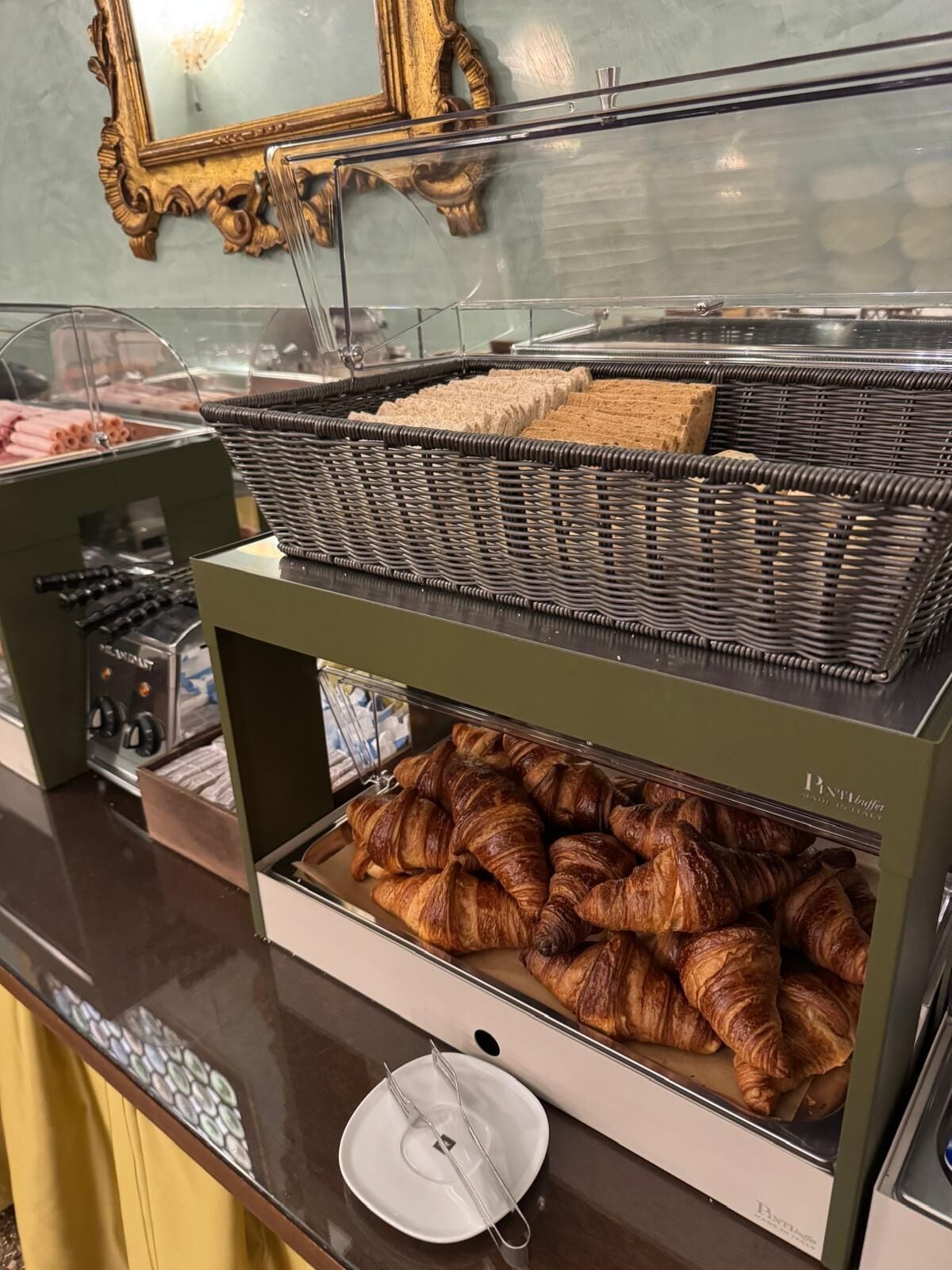A bakery display with pastries and a bread basket.