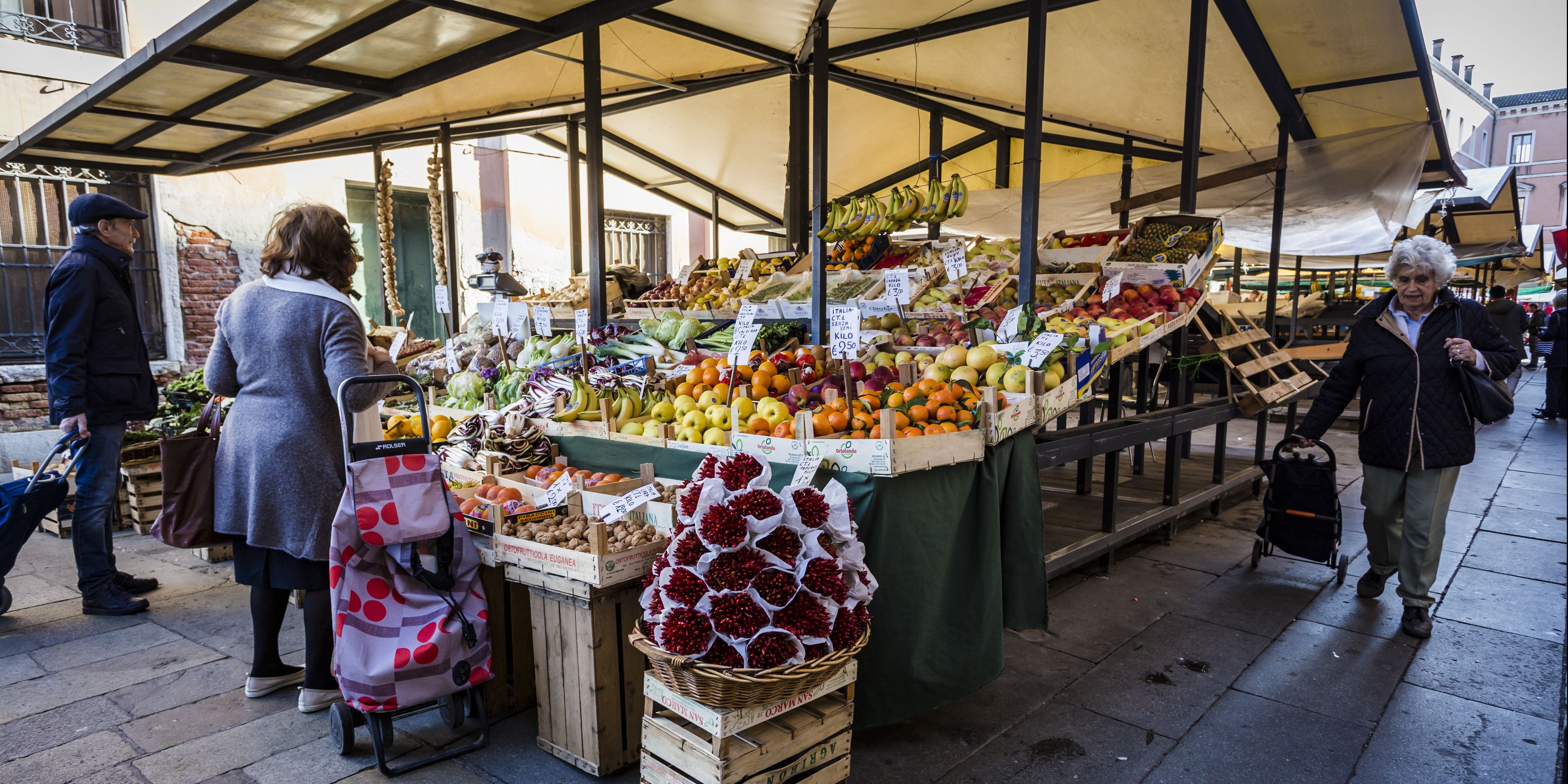 A market stall with various fruits and vegetables on display.