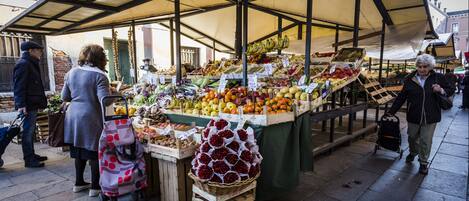 A market stall with various fruits and vegetables on display.