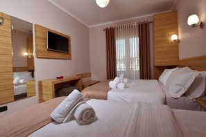 Relax in this stylish room with a large bed, flat-screen TV, and a window offering a view of the outside.