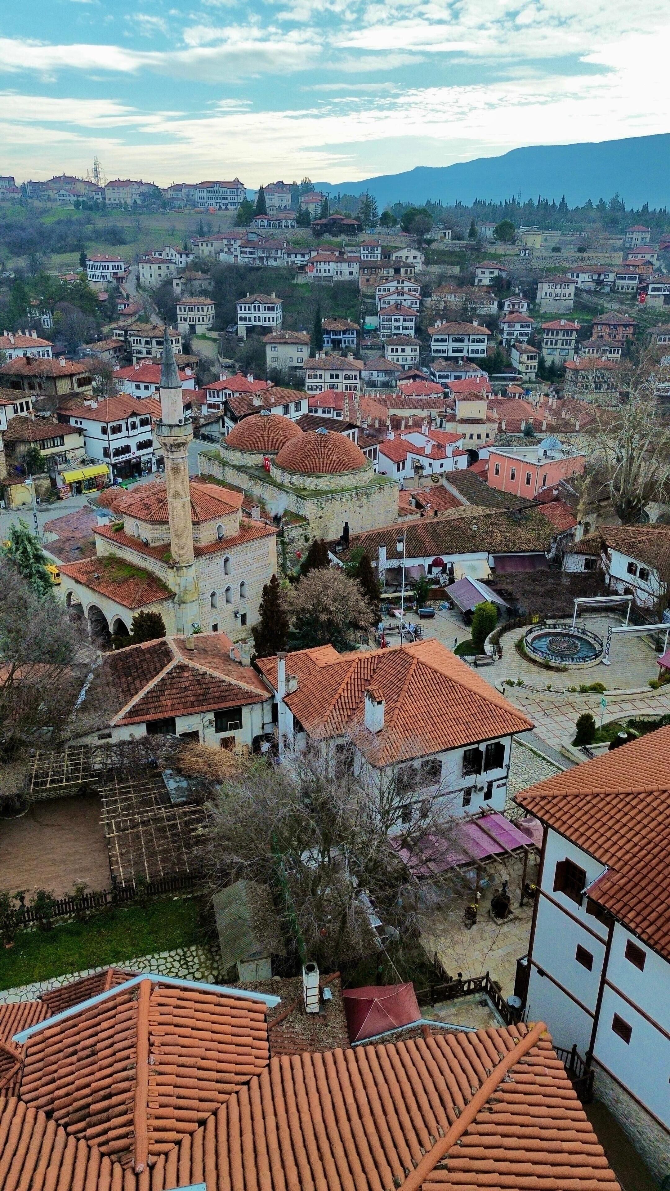 A town with historic architecture, including a prominent tower and domed buildings.