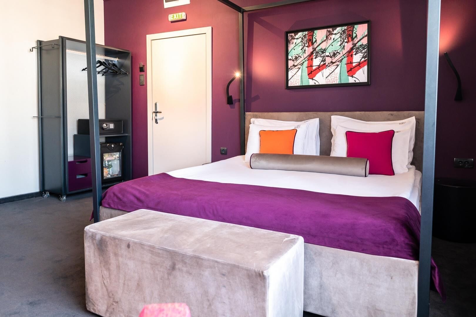 A bedroom with a bed, a wardrobe, a desk, and a chair.