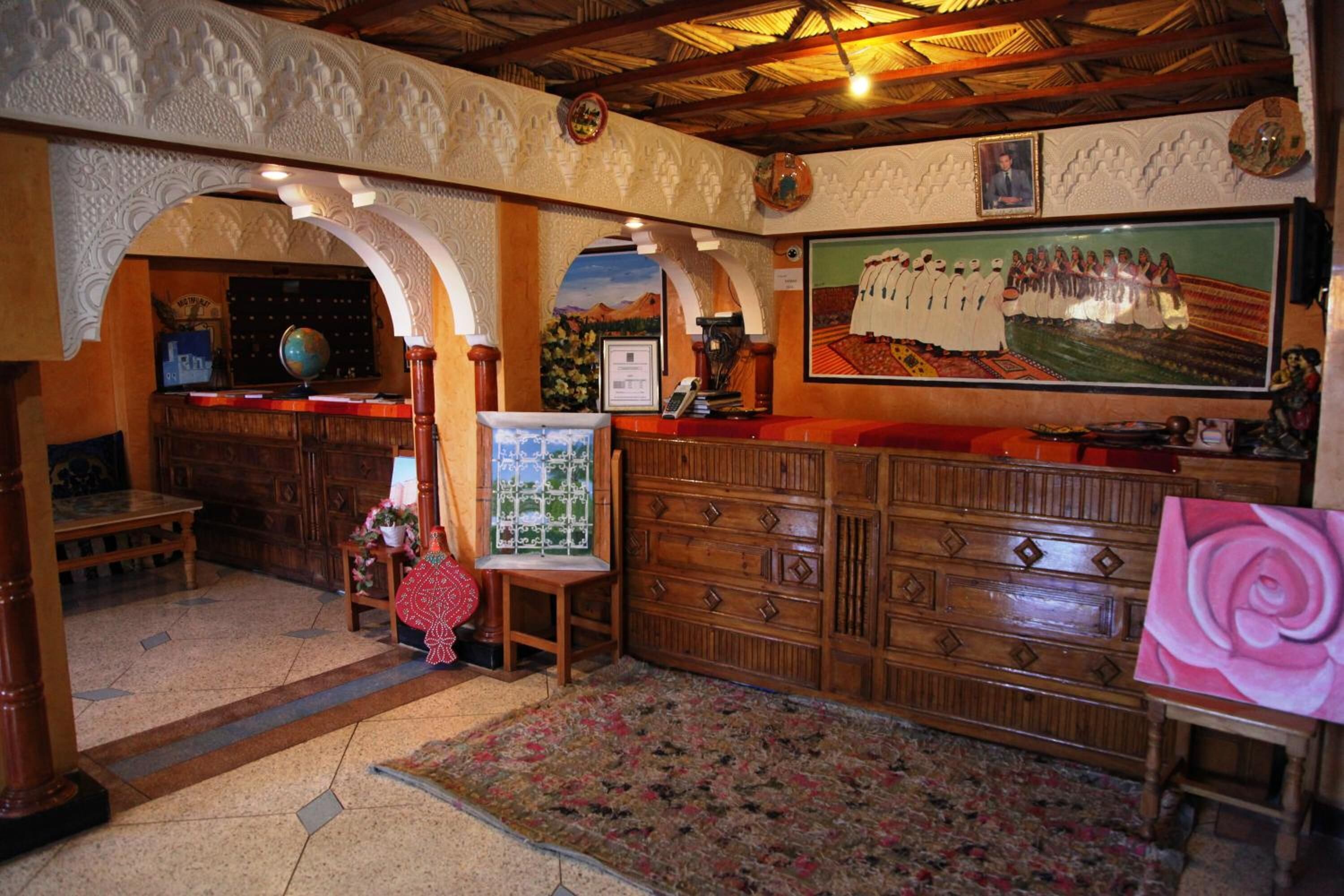 A room with wooden furniture, a globe, a framed painting, and a floral rug.