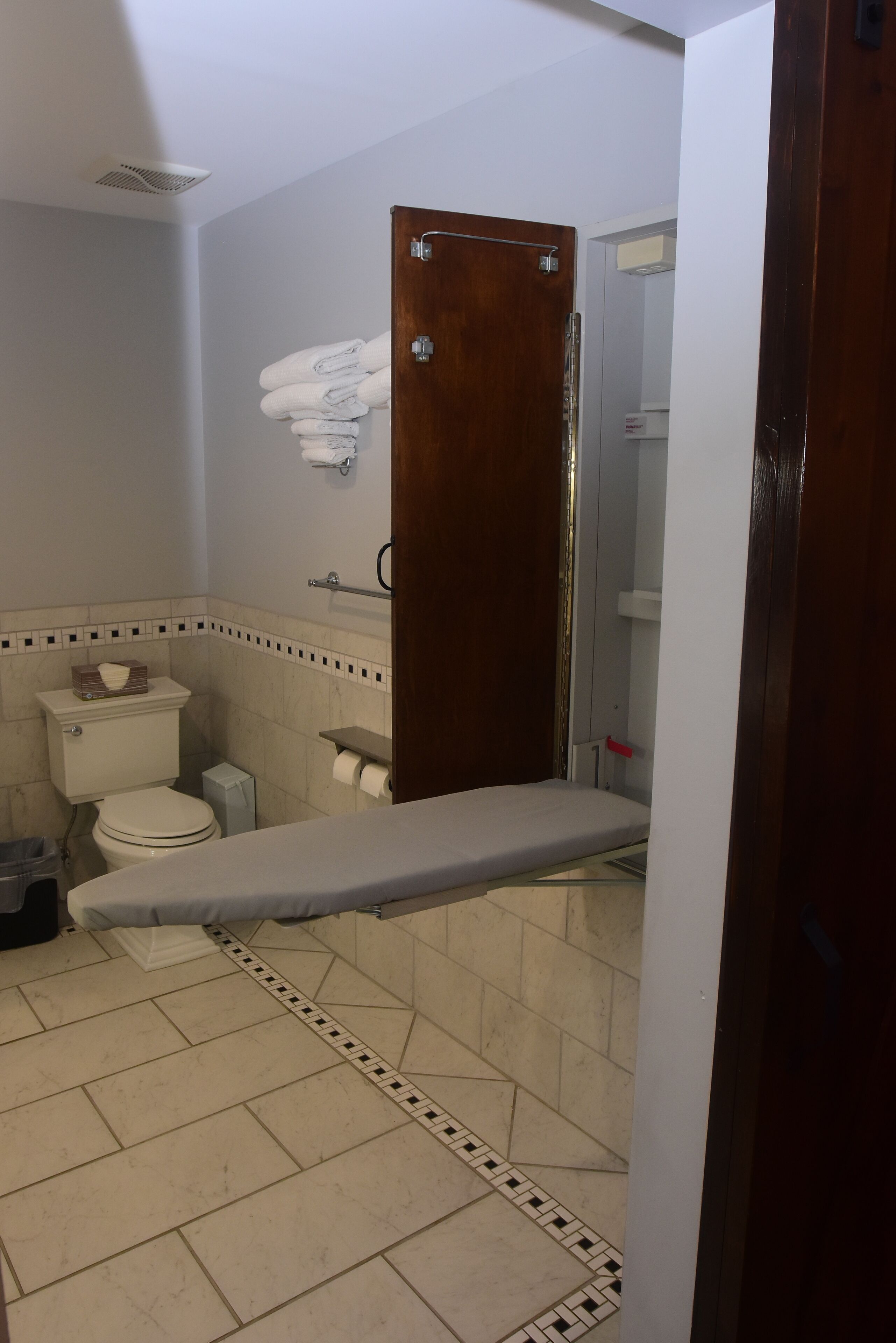A bathroom with a toilet, sink, and shower area.