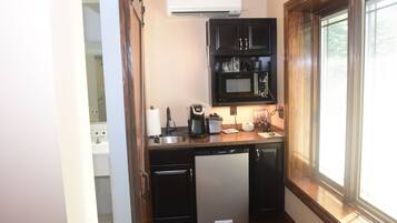 Una cocina compacta equipada con lavavajillas, microondas y cafetera.