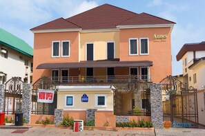 A two-story building with a sign indicating it is now open. - Annes Luxury Suites Ltd (Lagos)