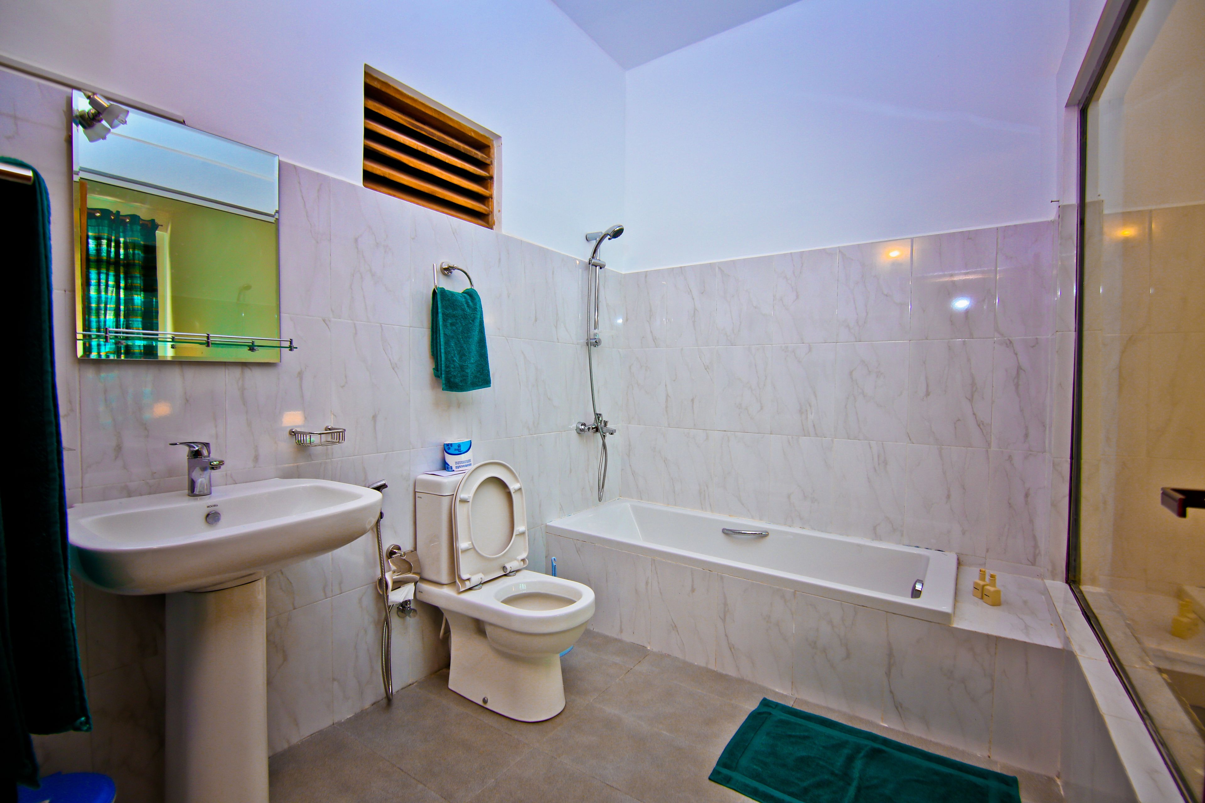 A bathroom with a sink, toilet, and bathtub.