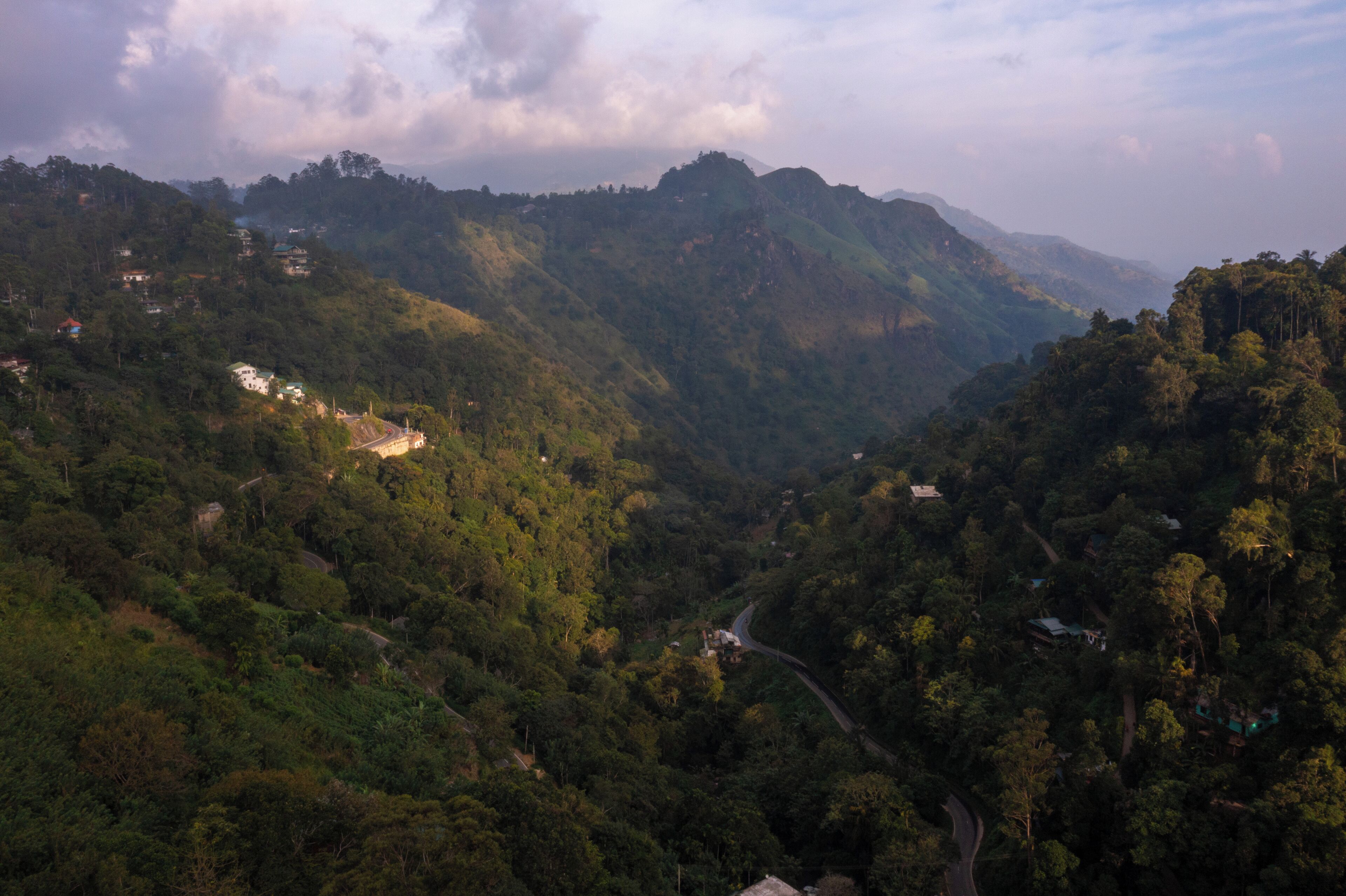 A mountainous landscape with winding roads and scattered buildings.