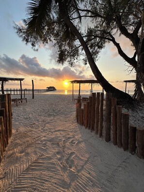 A beach with wooden structures and a wooden fence. - Kiwengwa Bungalow Boutique Resort (Kiwengwa)