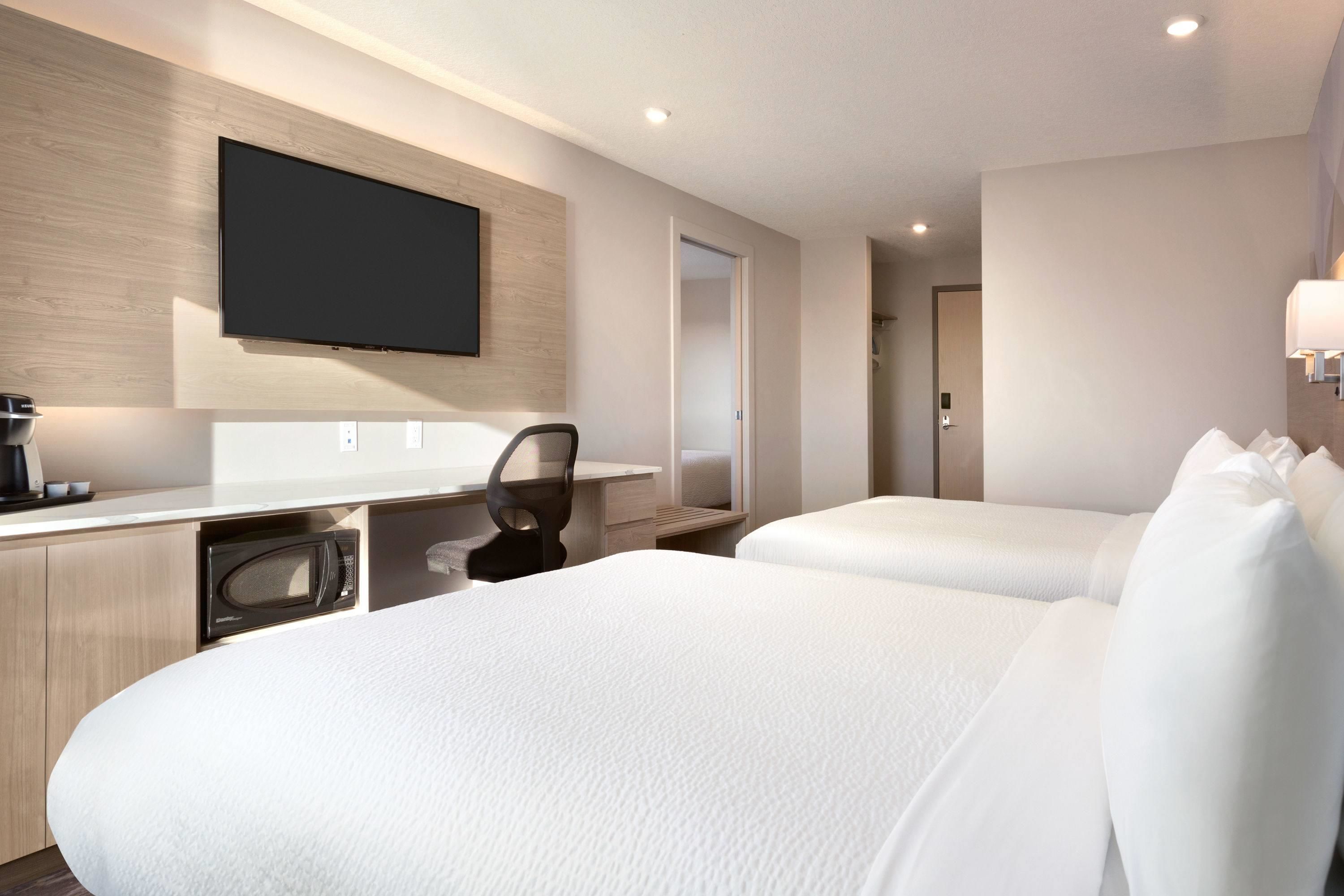 family suite, multiple beds | desk, laptop workspace, blackout curtains, iron/ironing board