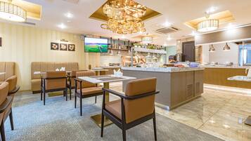 A modern restaurant with booths, tables, and a bar area.
