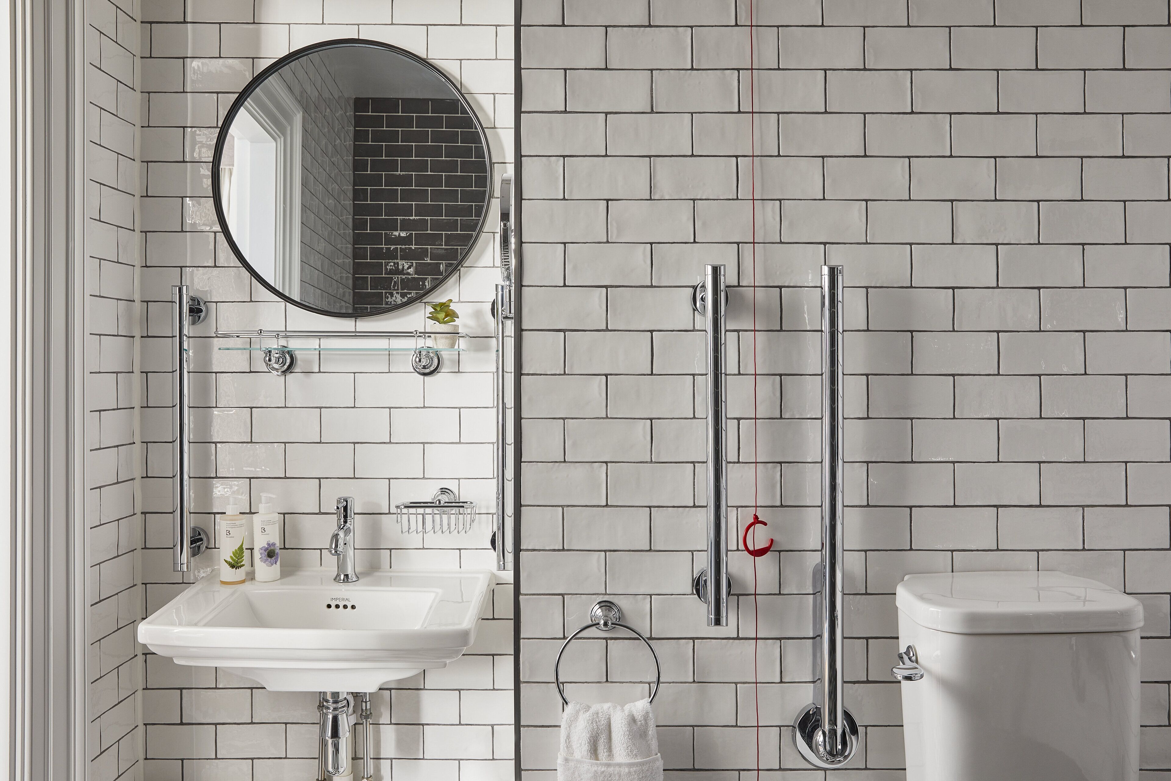 A bathroom with a white sink, mirror, and toilet.
