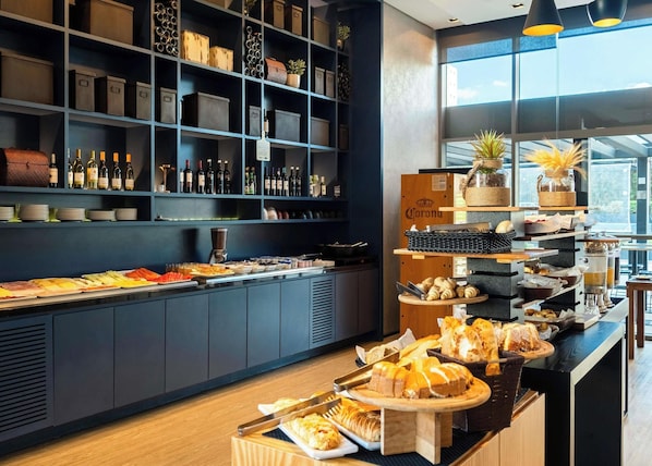 A buffet area with various food items and a wine selection. - Mercure São Paulo Barra Funda (São Paulo)