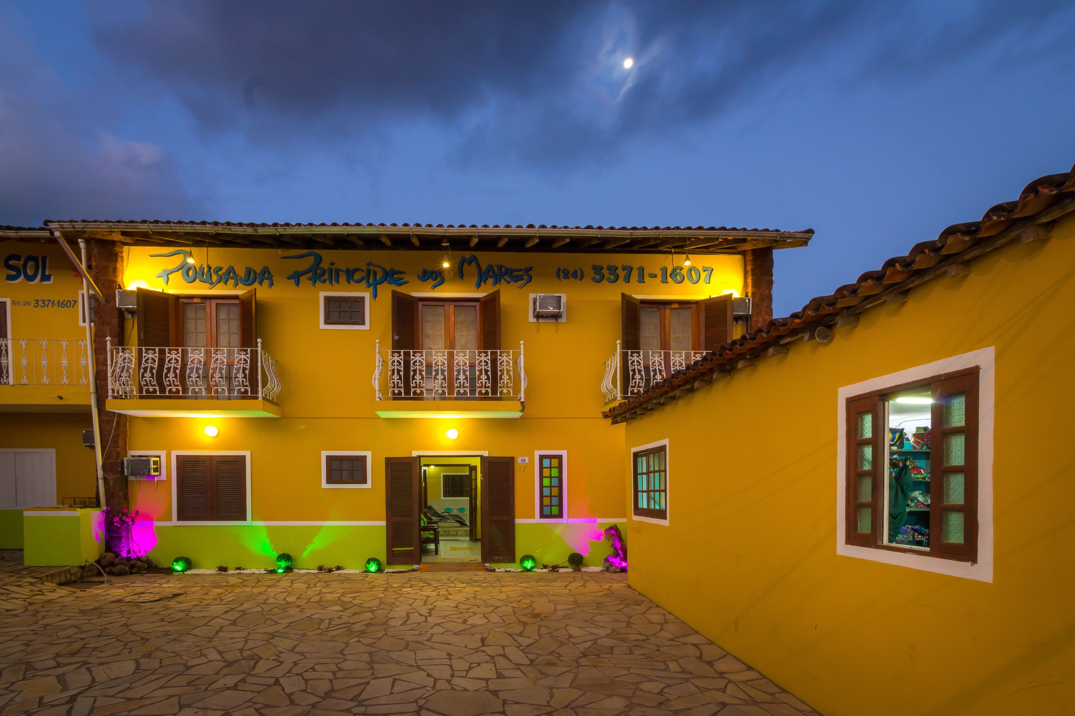 A yellow building with balconies and a sign that reads "Pousada Princesa de Marsa".
