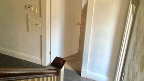 A staircase leading to a landing with a light fixture above. -  Minutes from Downtown, Pittsburgh’s international airport,  & Sports’ arenas! (Pittsburgh)