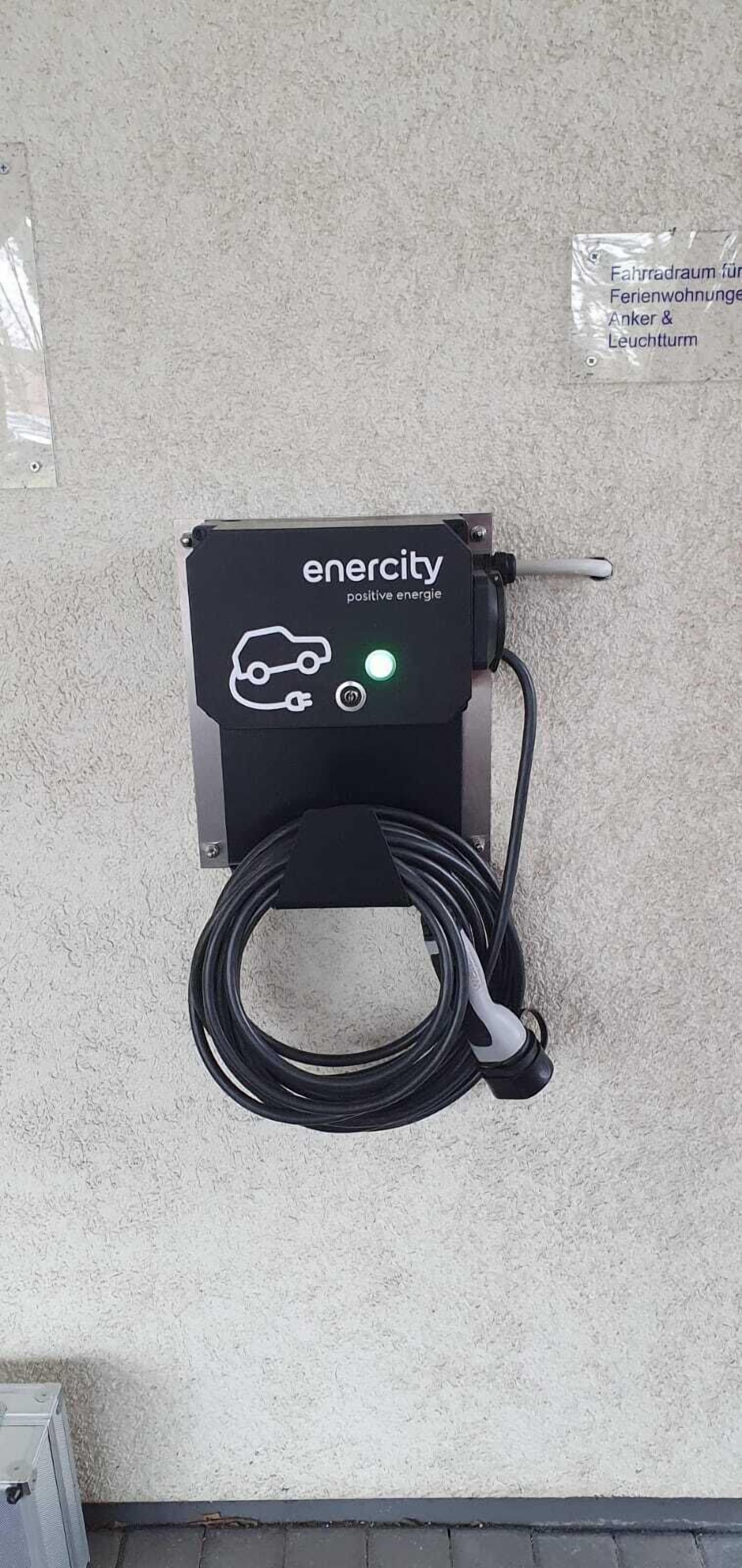 An electric vehicle charging station with a cable connected to it.