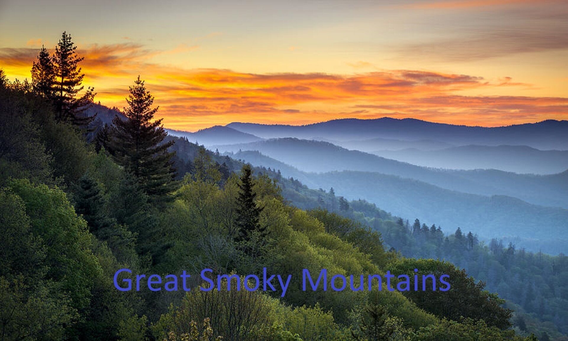 A scenic view of the Great Smoky Mountains with dense forest and a sunset.