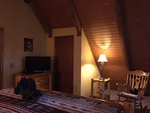 Relax in this inviting room with a comfortable bed, TV, and cozy seating area.