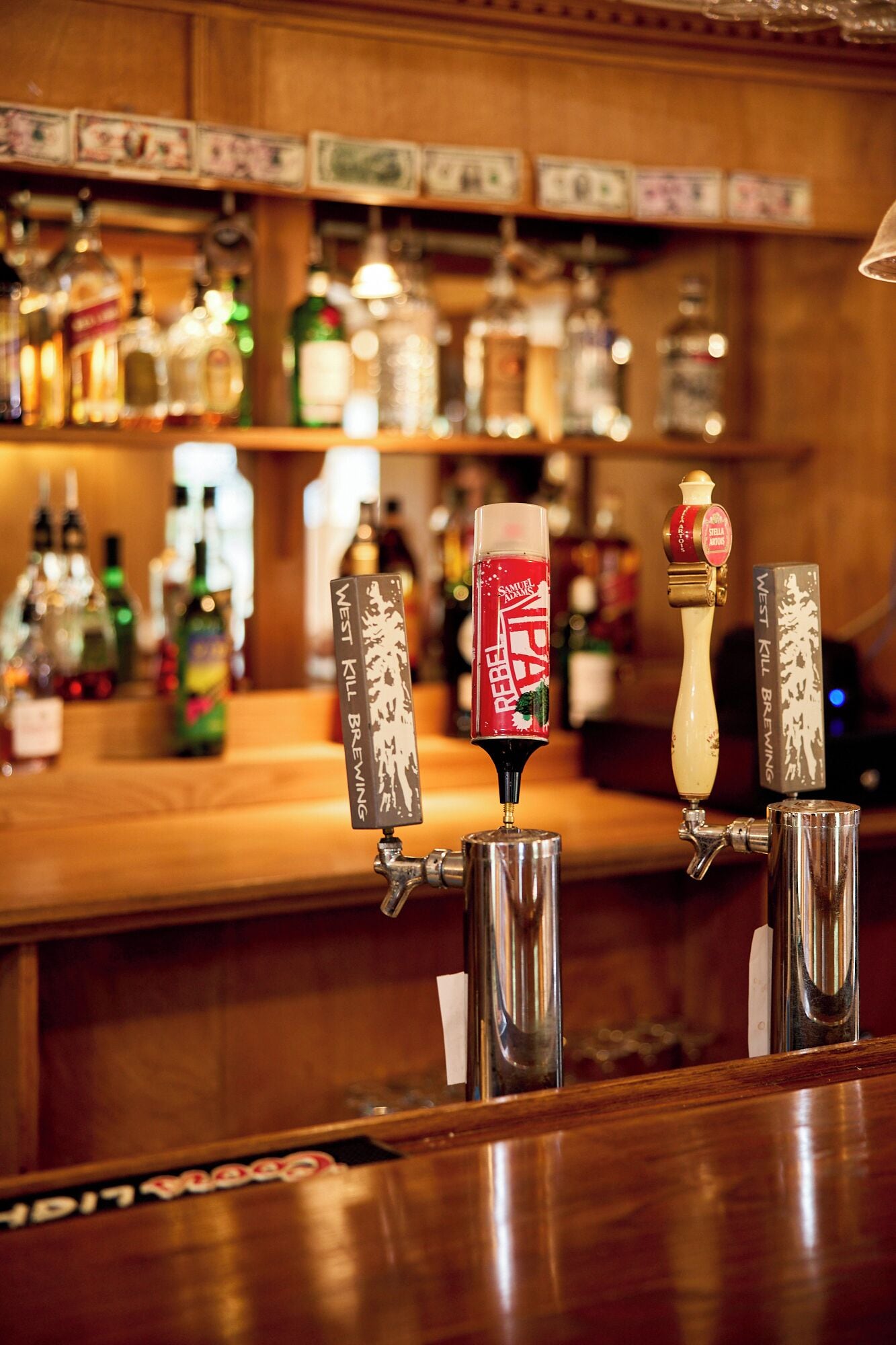 A bar with multiple taps, including one labeled 'Samuel Adams.'