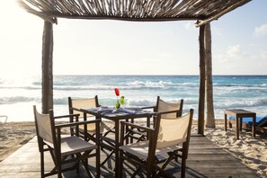 On the beach, white sand, beach cabanas, sun loungers