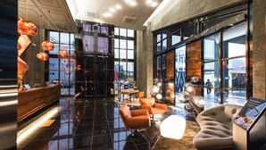 A modern lobby with a reception desk, seating area, and large windows offering views of the city. - Best Louis Hamilton Hotel Changwon (Changwon)