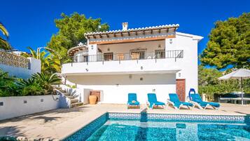 Guests can enjoy a balcony with a view of the pool from this two-story building.