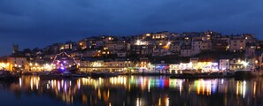 A waterfront town with buildings reflecting colorful lights on the water. - Lovely apartment located directly on the Quay overlooking Brixham Harbour (Brixham)