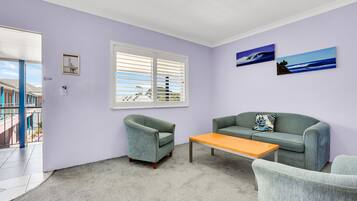 Deluxe Suite, Jetted Tub | Living area | 55-inch flat-screen TV with cable channels, TV, Netflix
