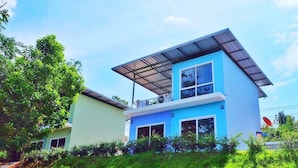 A modern two-story house with a flat roof and large windows. - The Box House (Krabi)